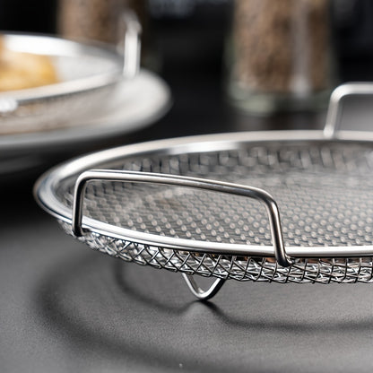 1 piece of a crisper basket that can be used for air frying and baking. This non-stick round tray comes with a mesh grill to catch grease, making it perfect for cooking crispy foods. Made of stainless steel, this basket is a handy kitchen tool and